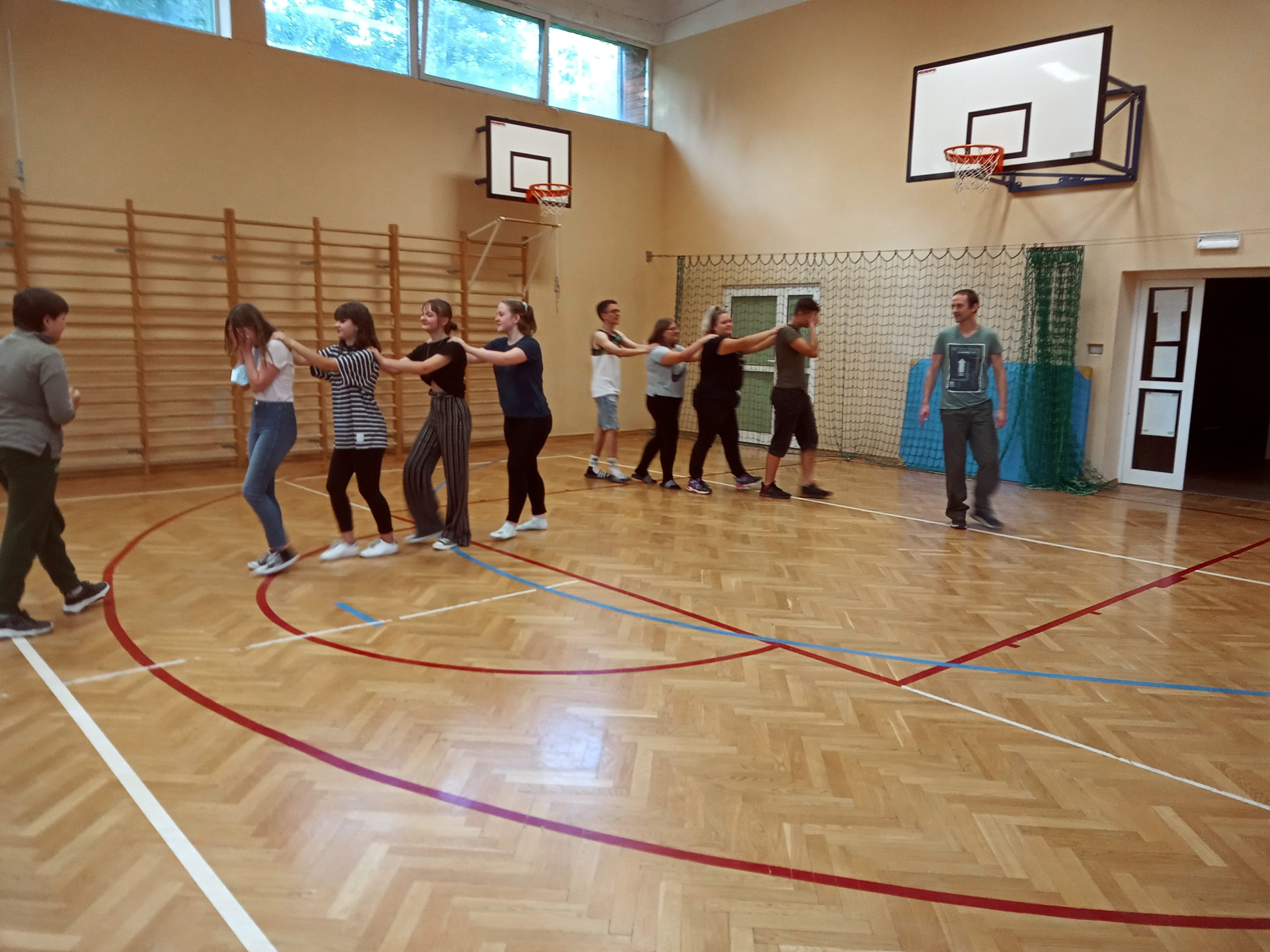 Dzieci ćwiczą na sali gimnastycznej